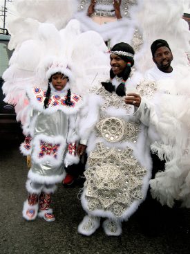 Big Chief Charles Taylor and members of the White Cloud Hunters Mardi Gras Indians, resplendent in white suits, outside the Backstreet Cultural Museum at Mardi Gras 2003