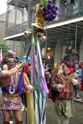 Society of St. Anne maskers, including an ancient Roman with a giant golden goblet mounted on a pole and overflowing with grapes, on Mardi Gras 2003