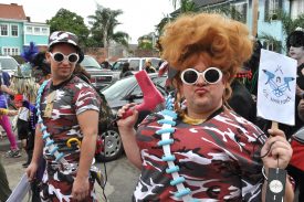 Fat Tuesday revelers, one of whom is brandishing a hair dryer, got up in camo as the 