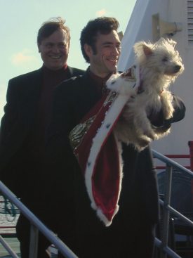 Sonny Borey and co-escort Derek Franklin, holding the regally attired Queen Puffer in his arms, descending the gangplank from the John James Audubon riverboat