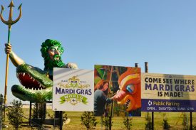 Signage and sculpture (featuring a Neptune-like figure, a.k.a Old Man River, astride an alligator) for Blaine Kern's Mardi Gras World