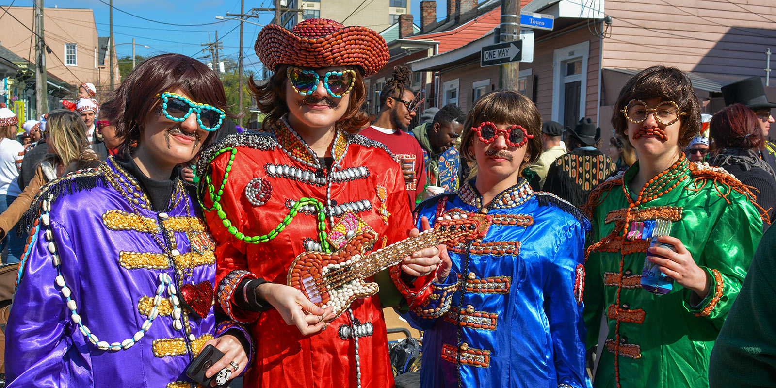 Four revelers dressed up as "The Beantles" for 2019 Krewe of Red Beans parade
