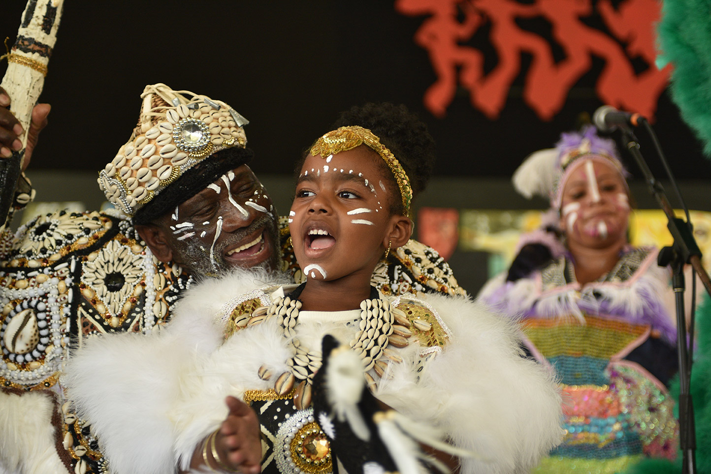 Big Chief Victor Harris of Spirit of Fi Yi Yi and the Mandingo Warriors with his granddaughter at the 2022 New Orleans Jazz and Heritage Festival